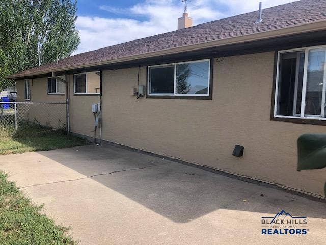 The back yard is fenced & includes a storage shed