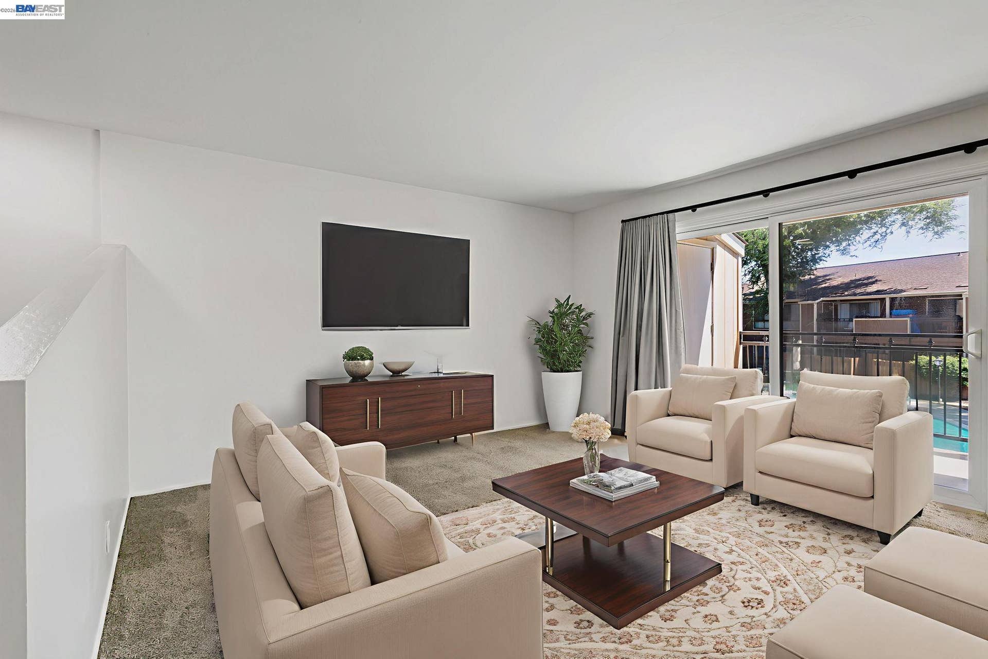 Large bright open living room with lots of wall space  for easy decorating.  This room is virtually staged.