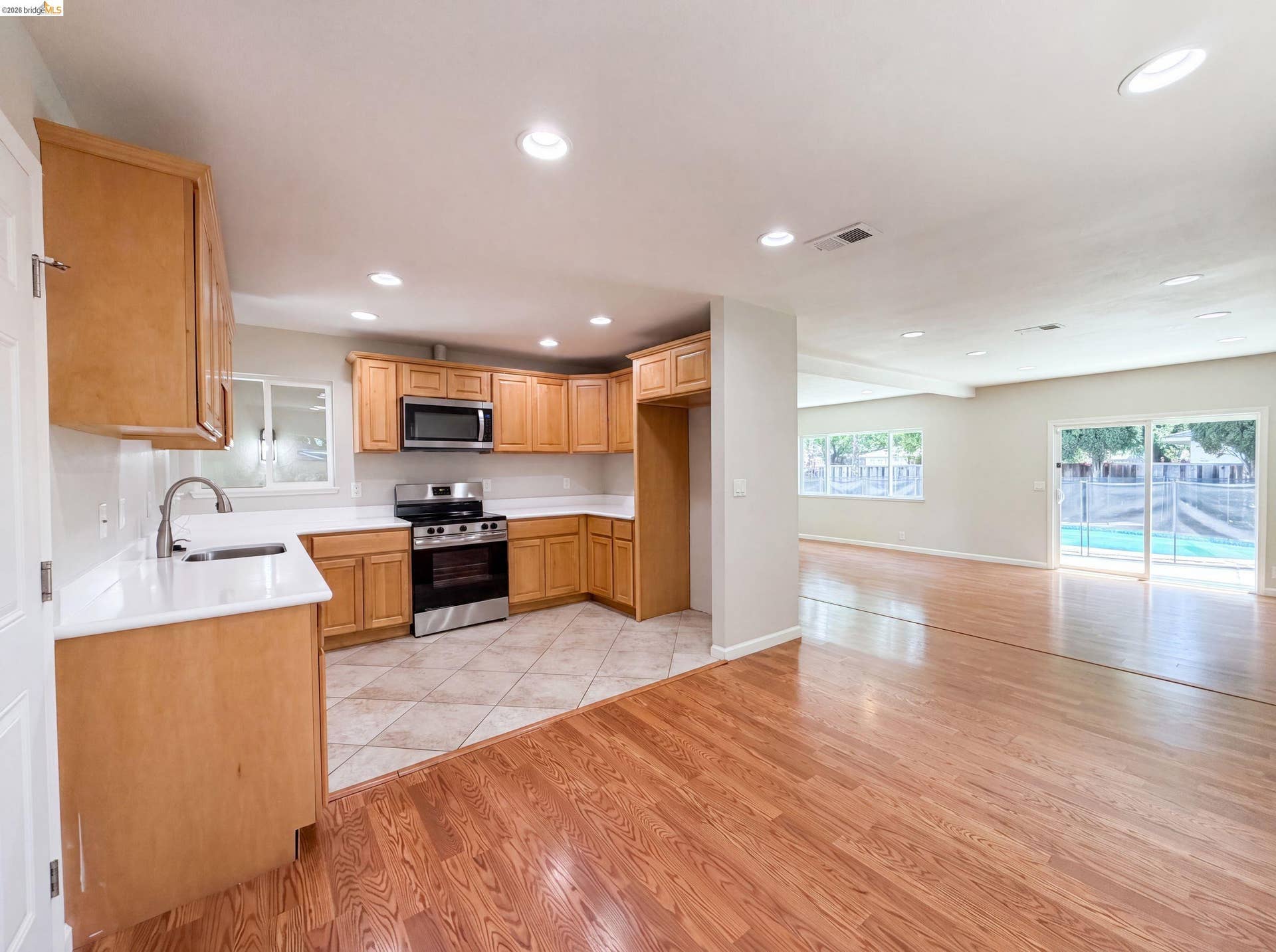 Kitchen featuring wood cabinetry, white countertops, stainless steel appliances, and recessed lighting
