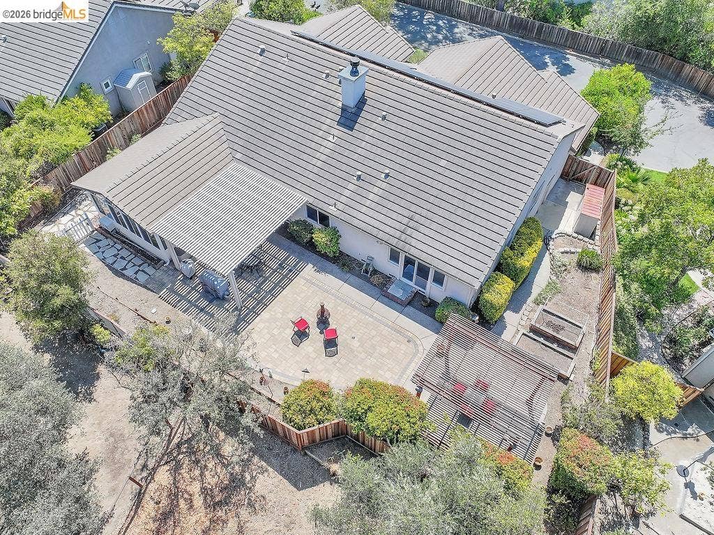 Expansive paver patio with a louvered pergola and a shaded outdoor living area