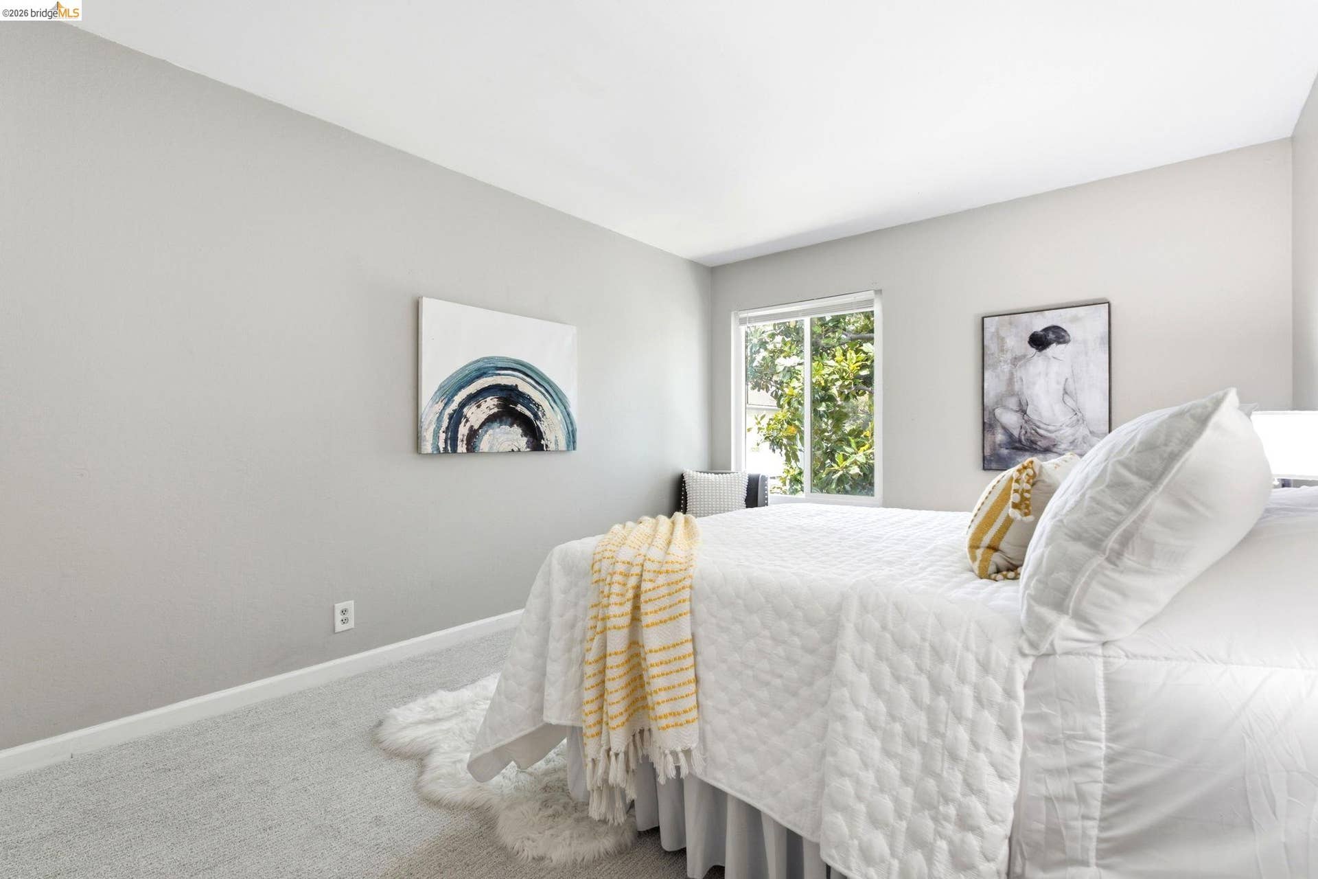 Bedroom with light gray walls, white trim, and light gray carpeting
