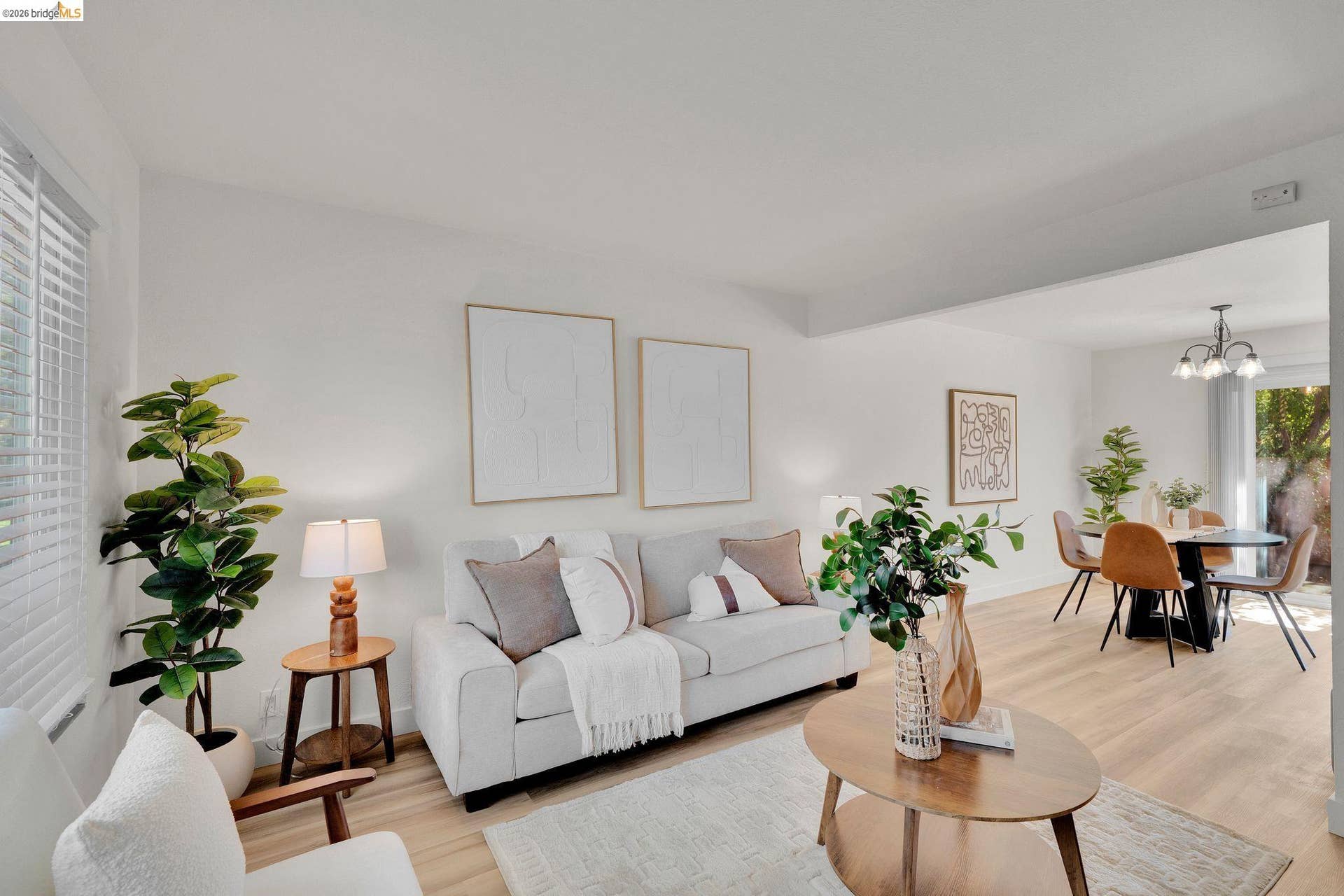 Open-concept living area with wood-finish flooring, recessed lighting, and white walls