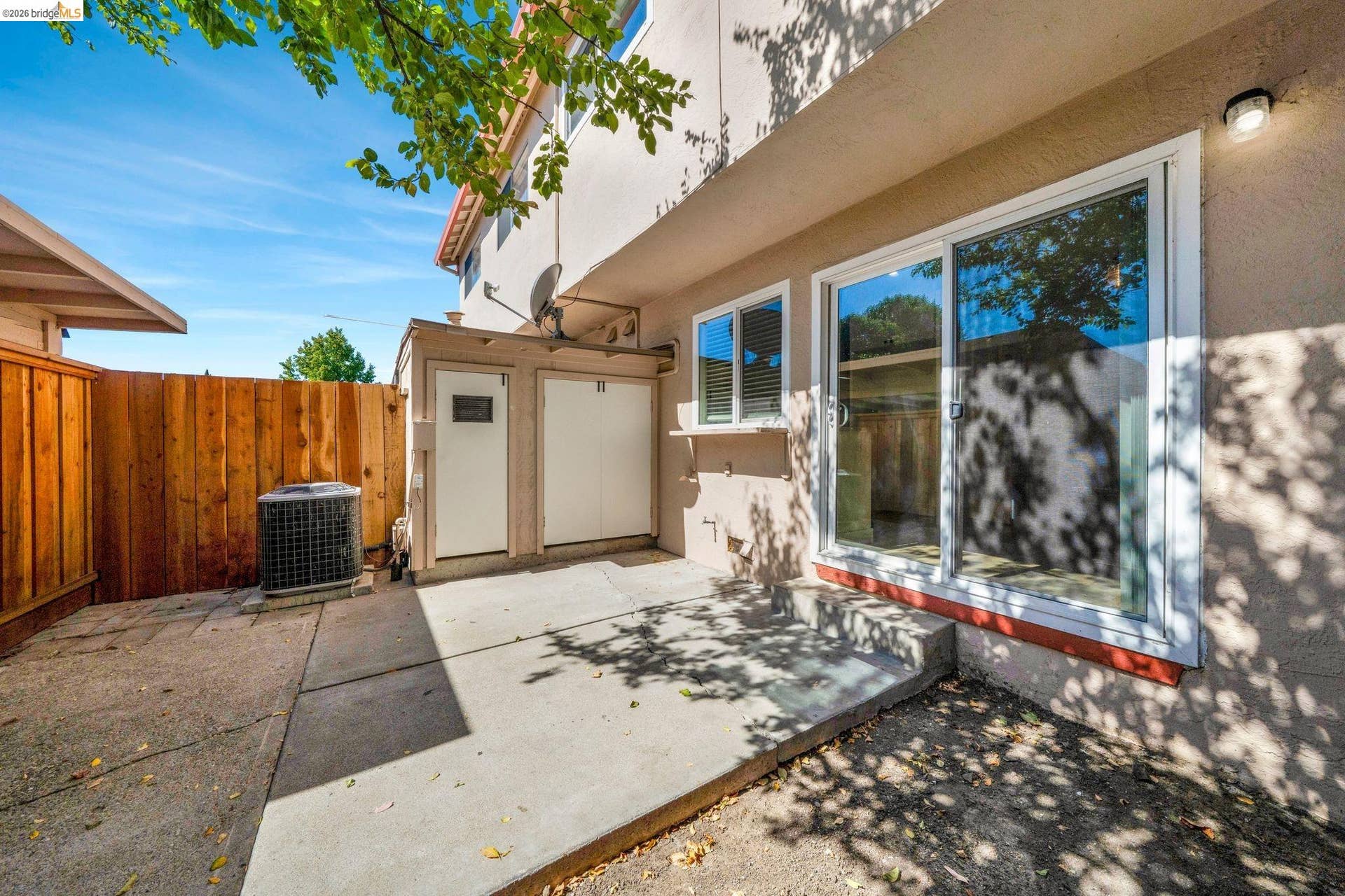 Concrete patio with sliding glass door access