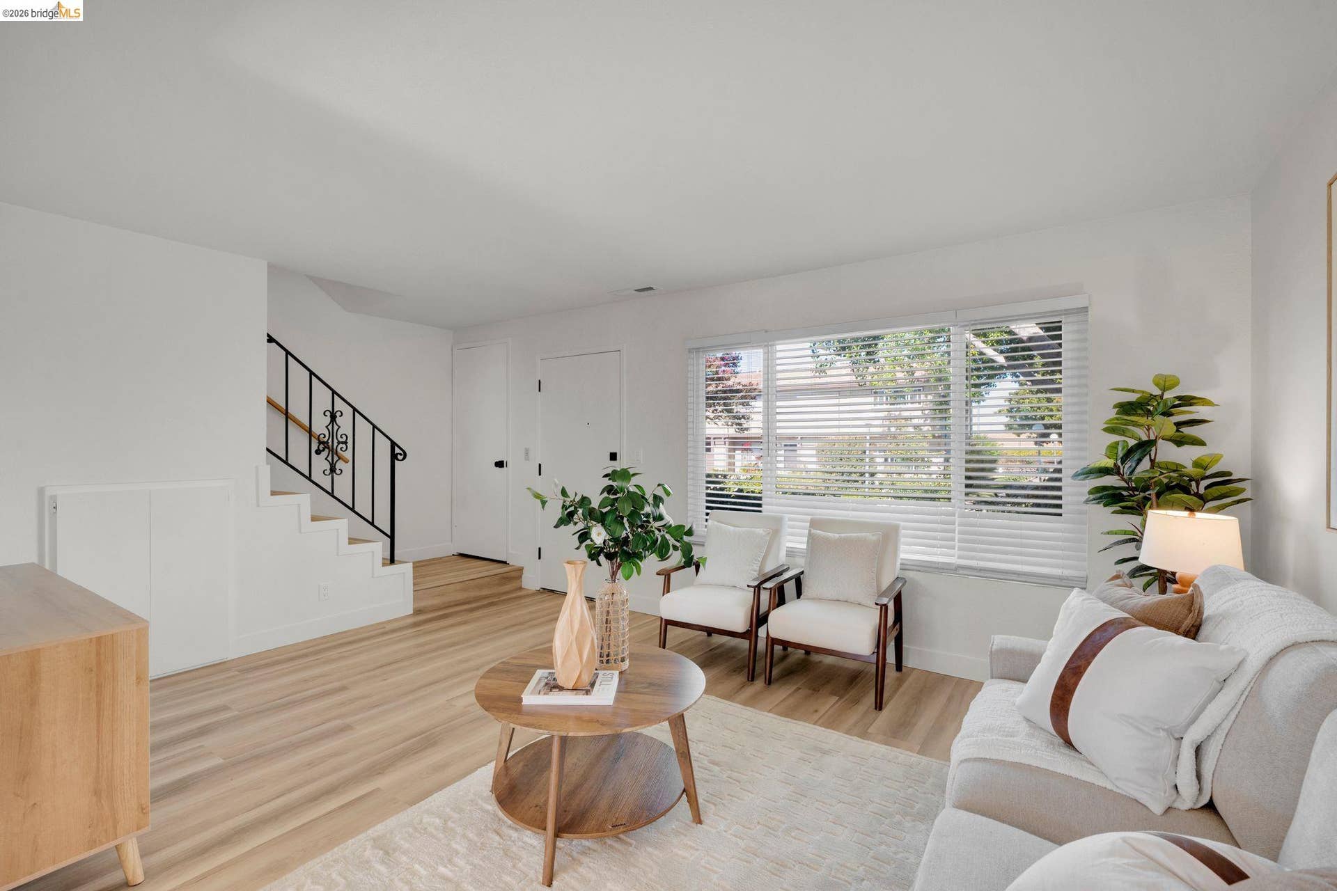 Light wood-finish flooring with white walls
