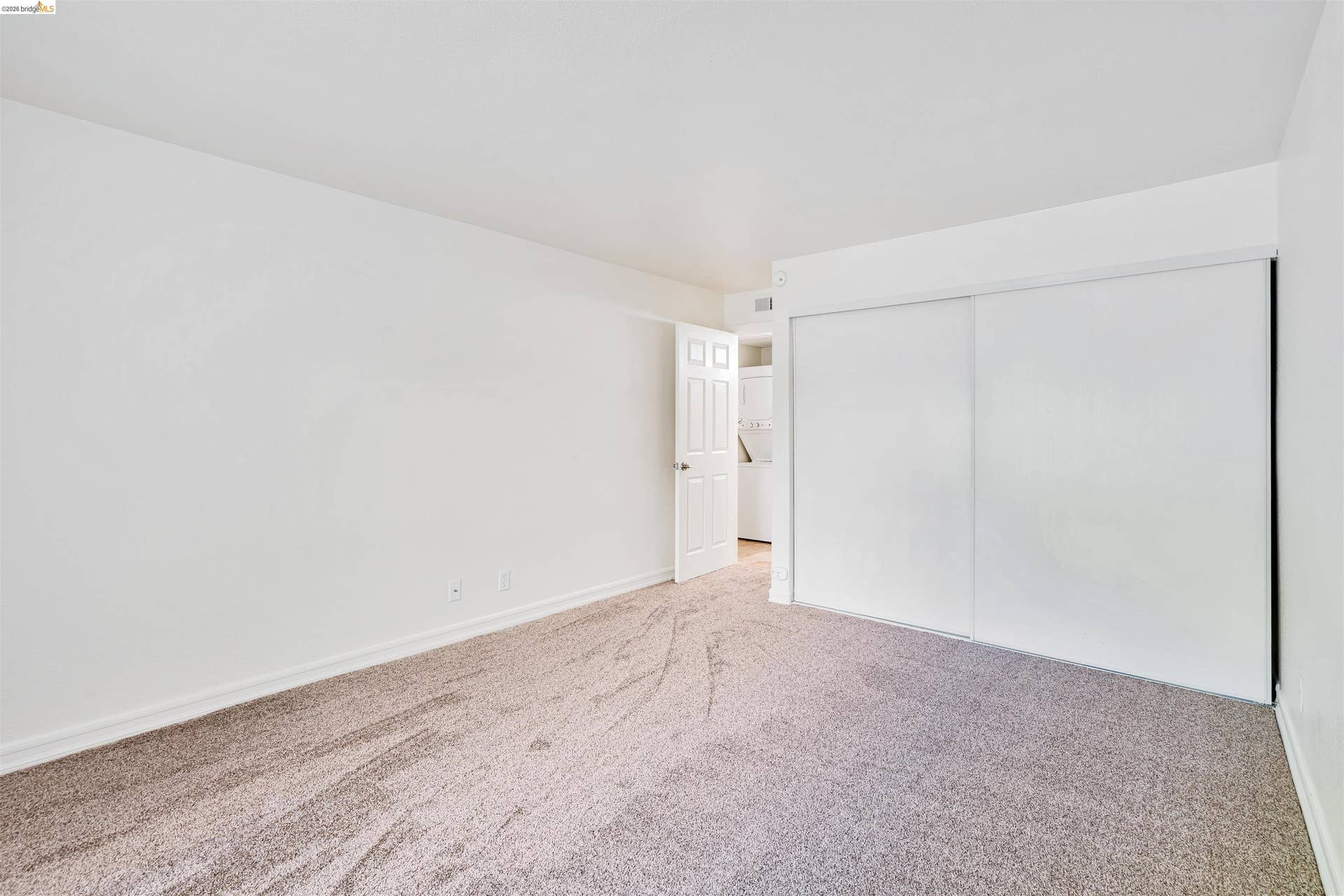 Plush carpeting, neutral wall tones, and white trim