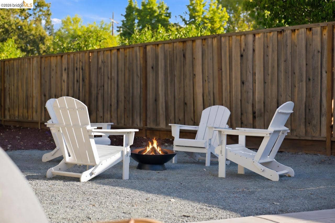 Gravel patio area featuring a fire pit
