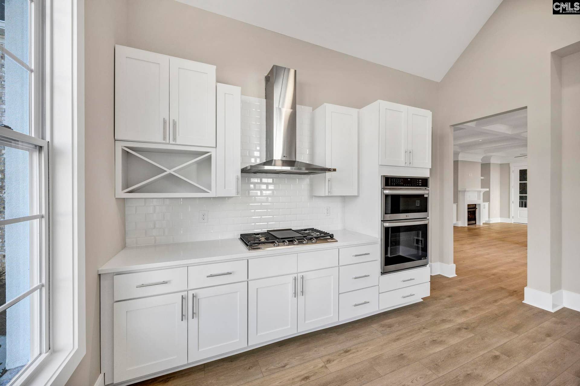 Gas cooktop with stainless range hood creates a stylish, functional space for everyday cooking.