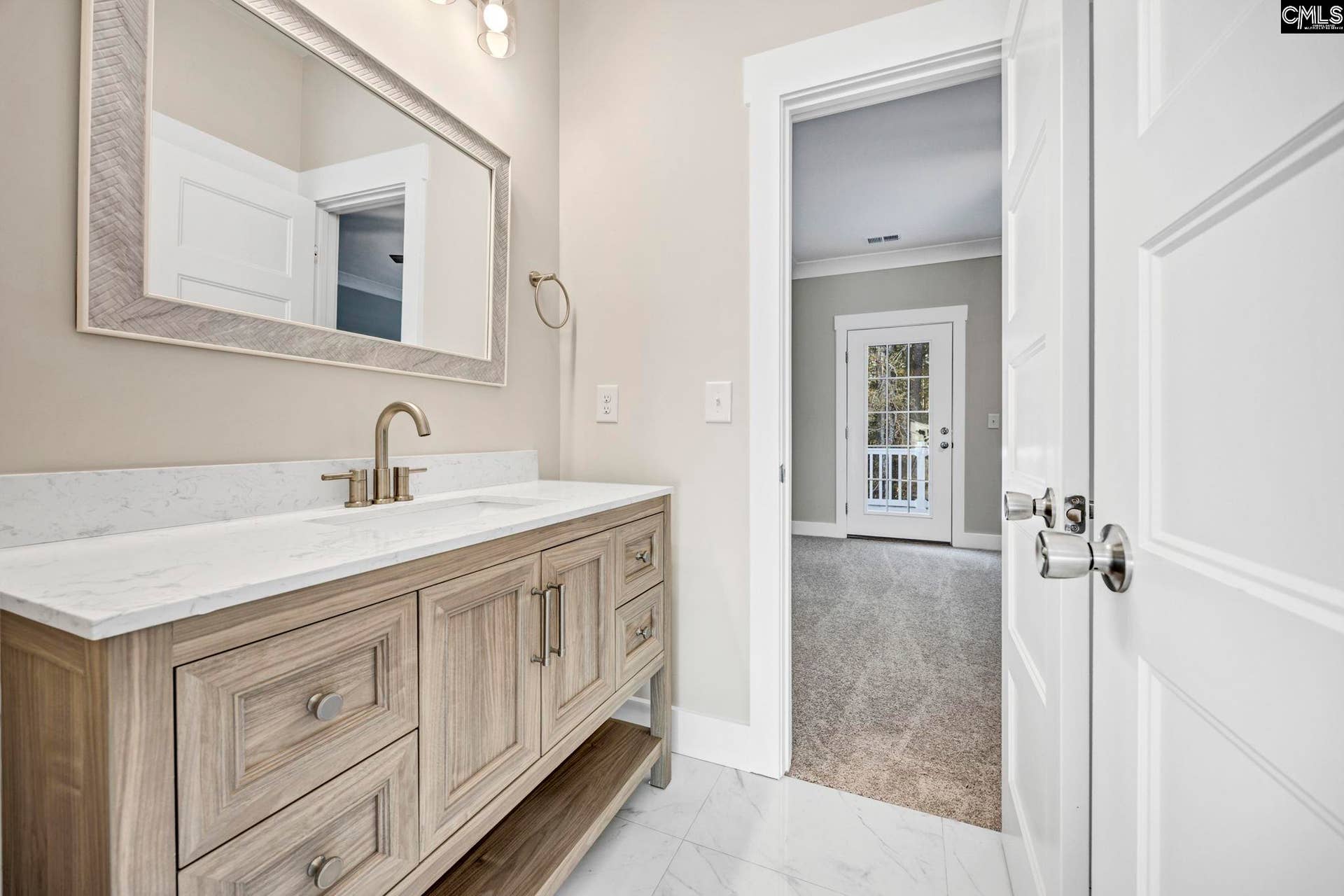 Upstairs Jack & Jill bath connects two bedrooms and features a spacious vanity with ample storage.