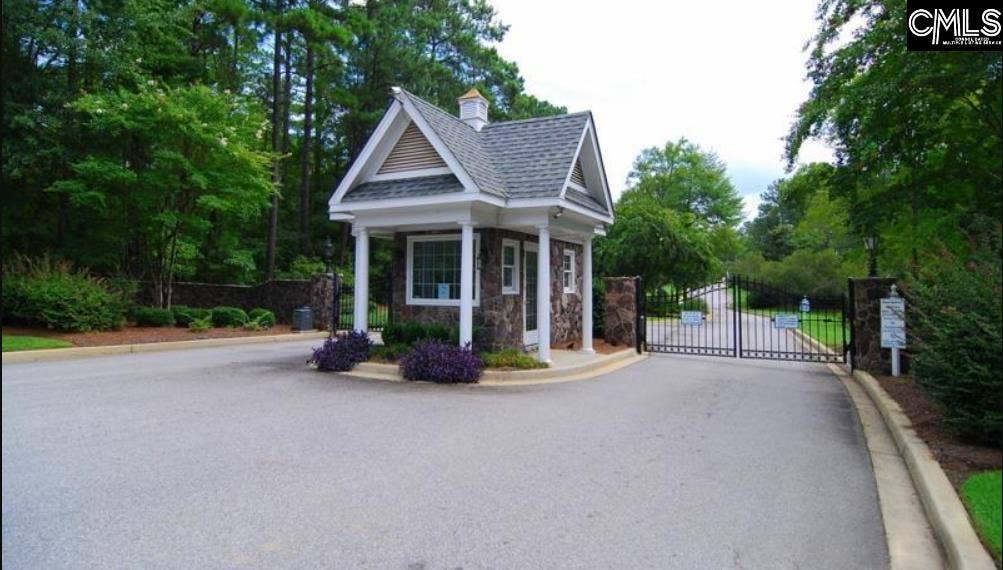 Gated Lake Murray community offers a private entrance surrounded by mature trees and landscaping.