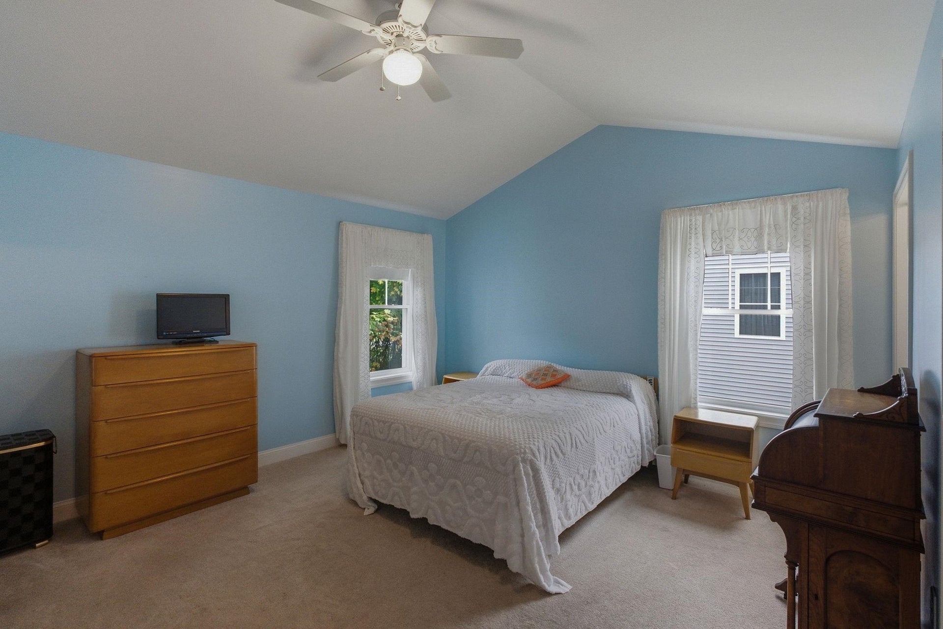 Primary bedroom is very large with a cathedral ceiling and fan